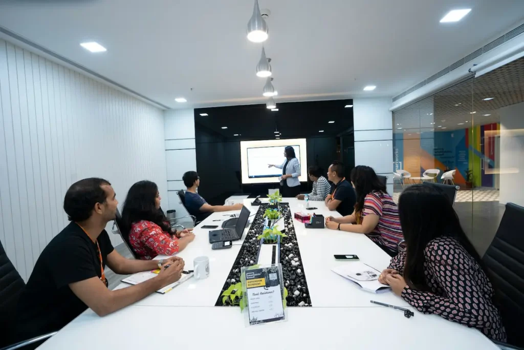 Woman presenting to a team in a corporate meeting room